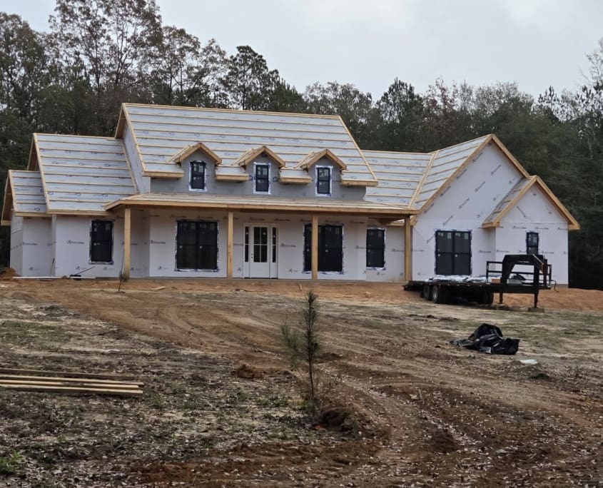 Elegant Elevated Home Roof Nearing Completion with Fireplace Finishing Touches